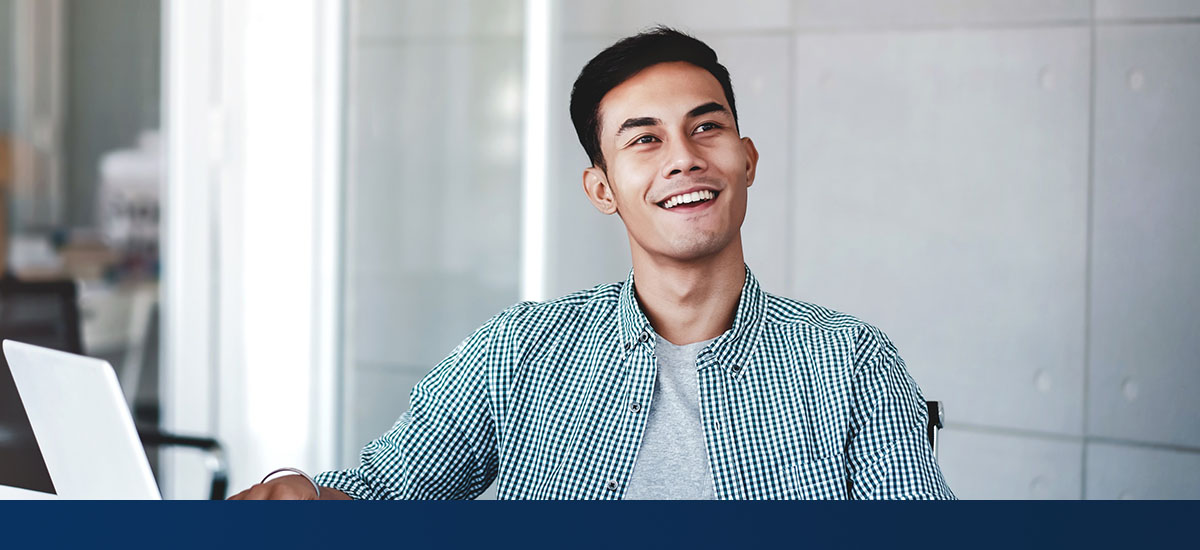 smiling man with laptop